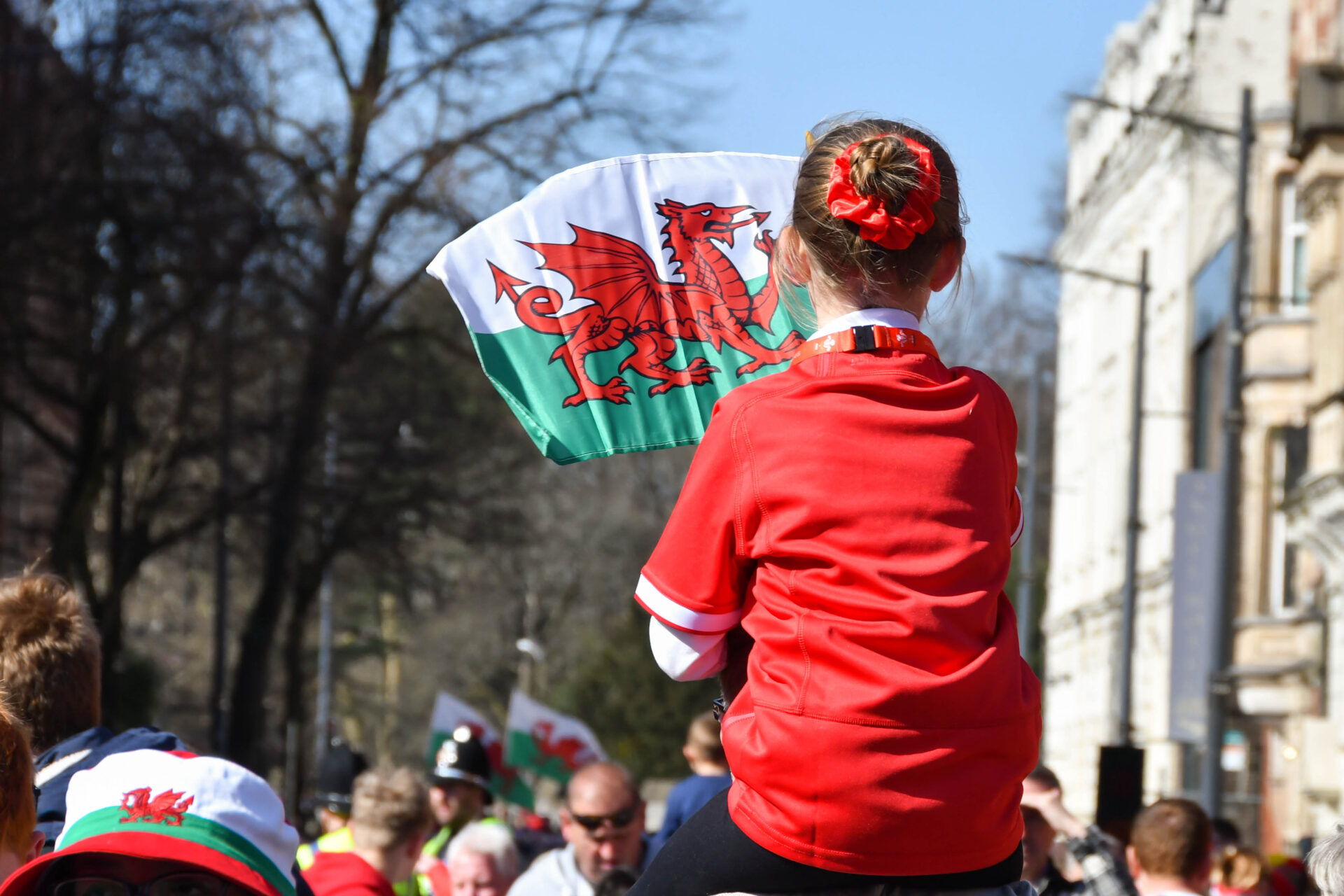 A young girl waving a Welsh flag