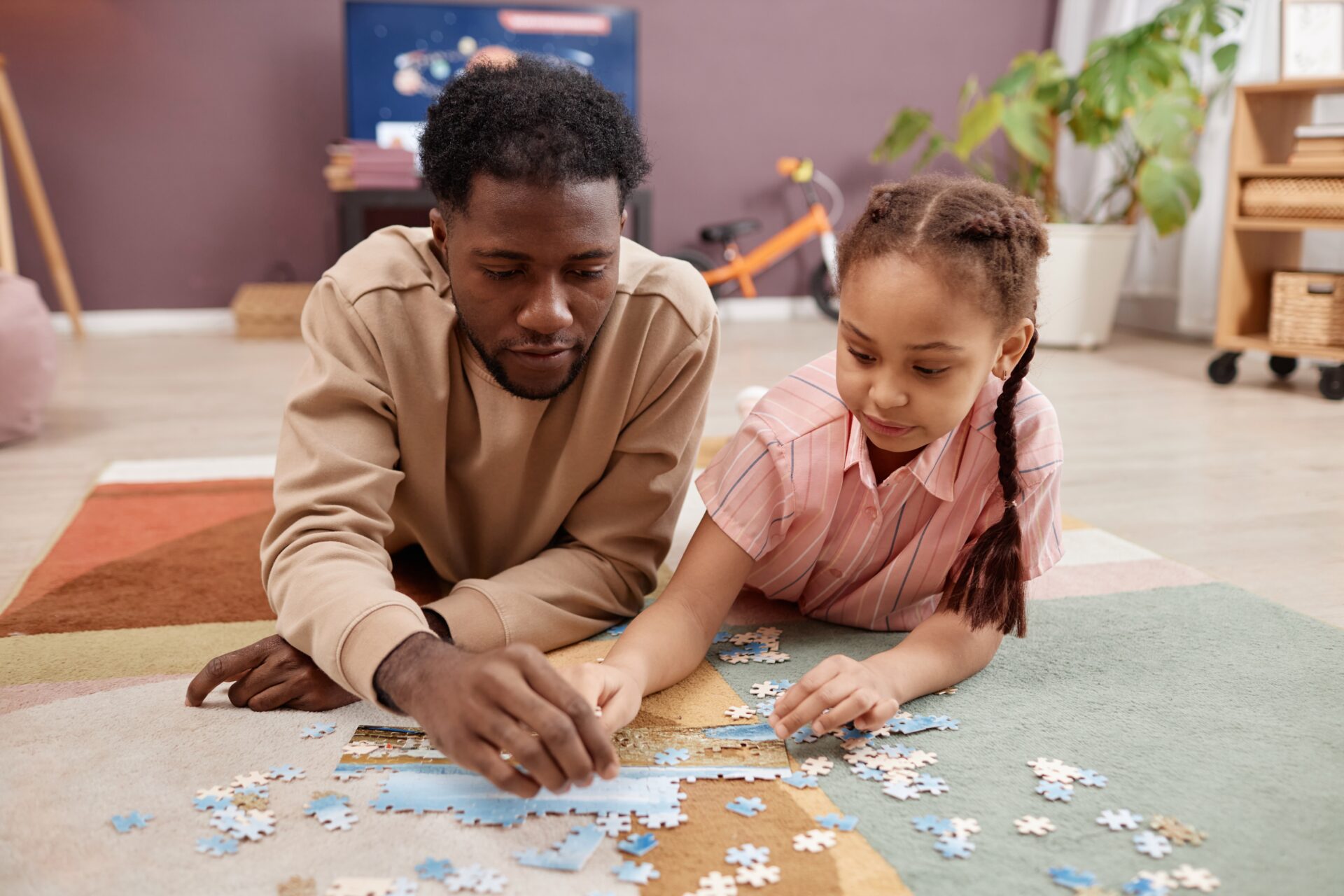 Father and daughter putting together a jigsaw together