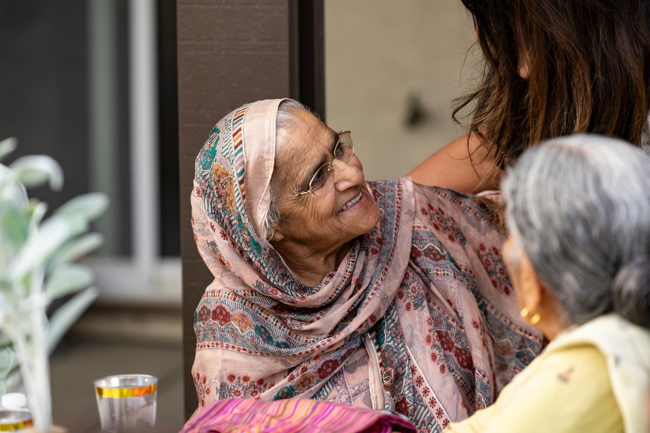 A senior woman wearing a patterned headscarf
