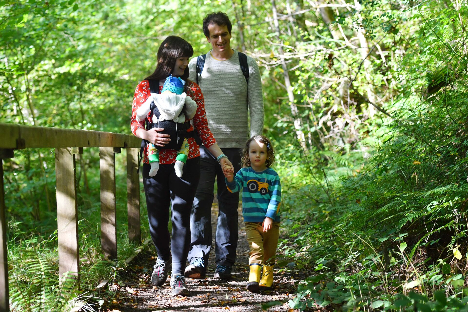 Young family walking in the woods.