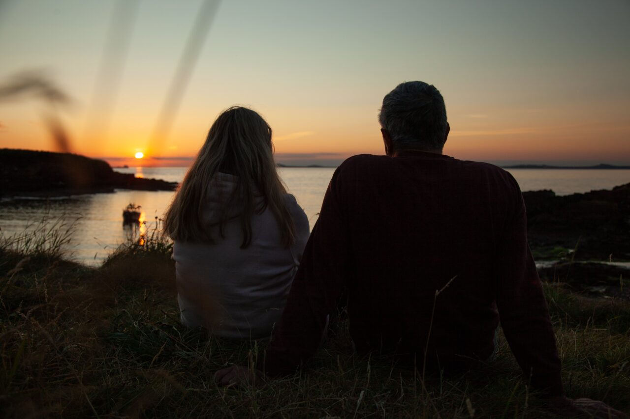Two people watching the sunset.