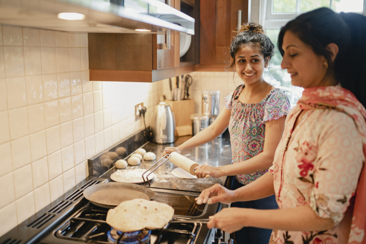 Two women baking bread together