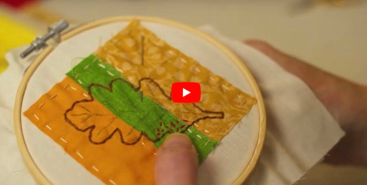 A person embroidering