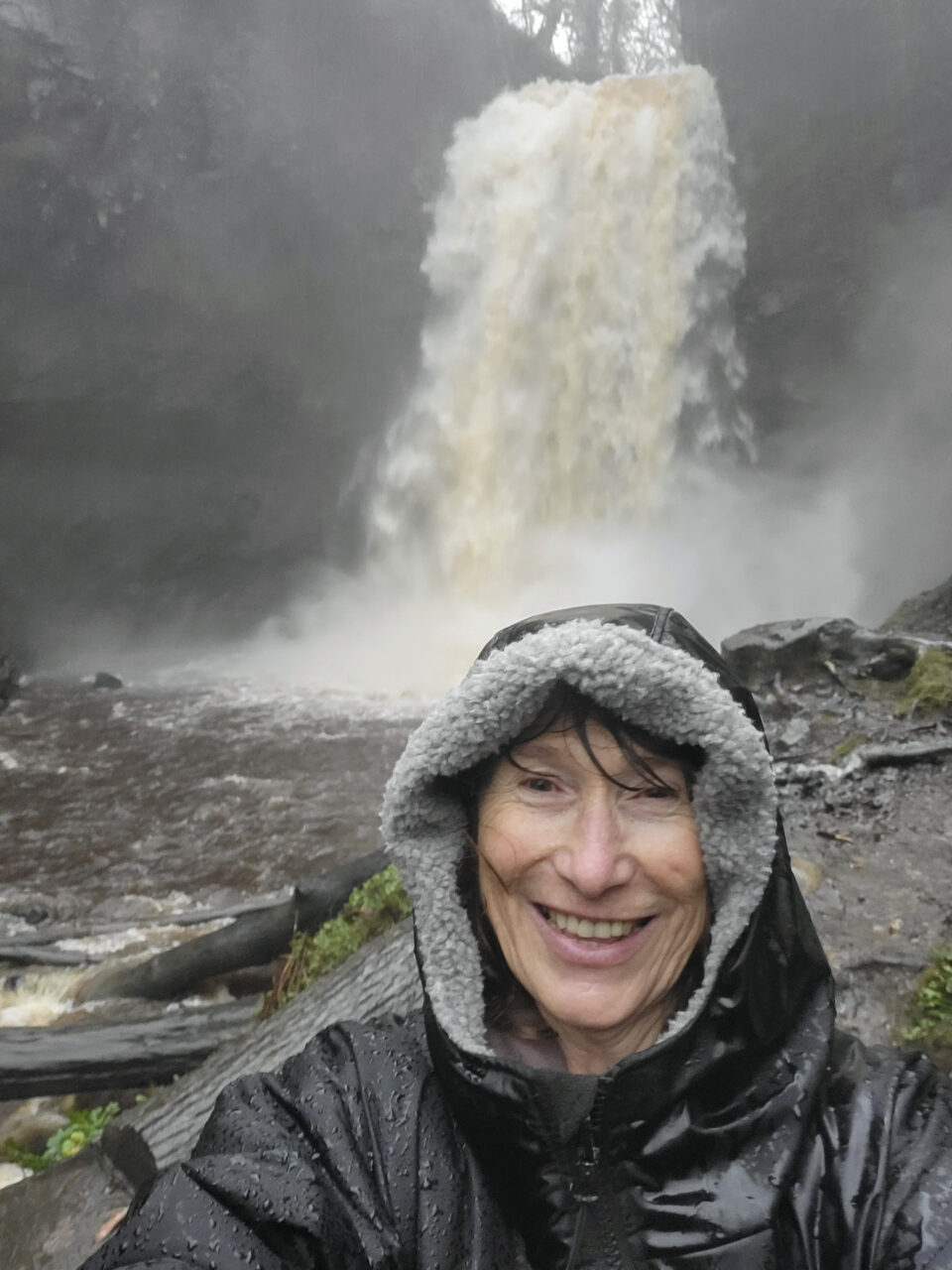 Woman taking a selfie at Henrhyd Falls