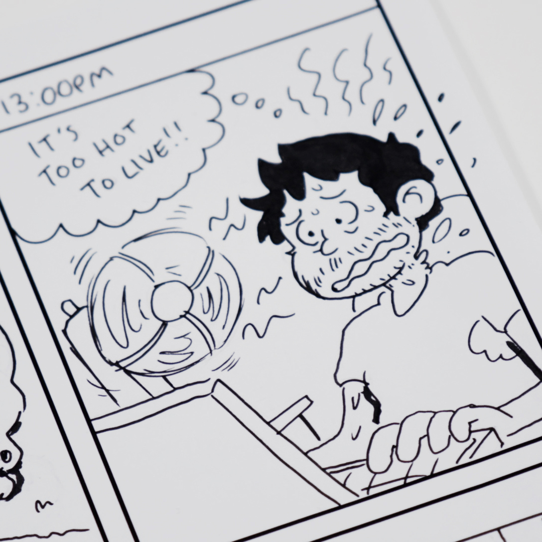 Close up of a comic panel with a cartoon person sitting in front of a laptop looking distressed. There's a desk fan blowing on them, and a thought bubble with the words 'It's too hot to live' hovers over their head.