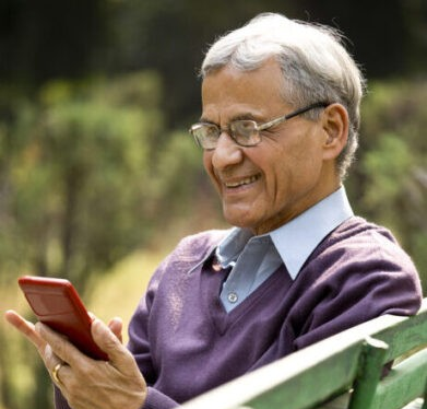 Elderly man reading content on phone