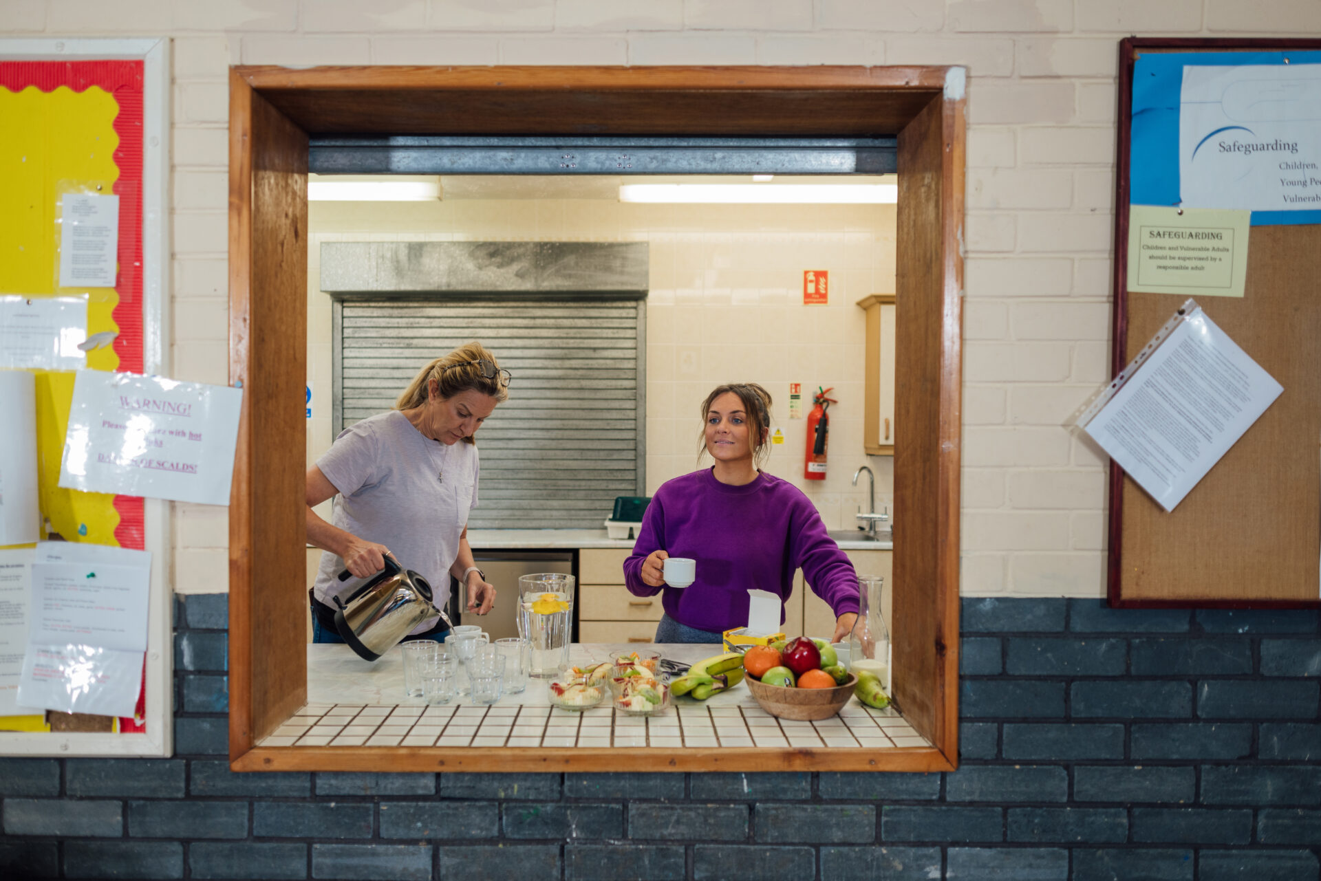 Photo of two women volunteering at a community centre